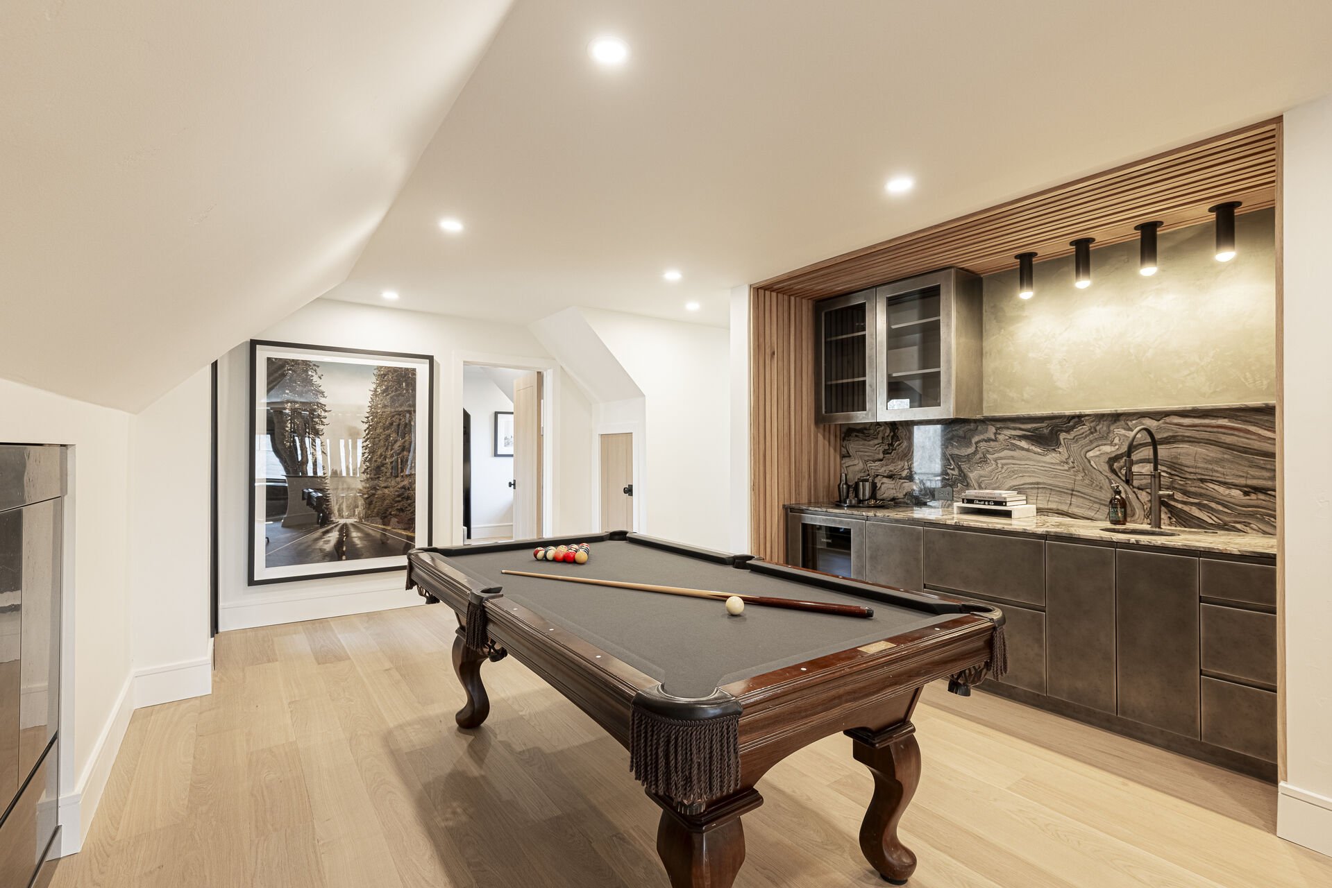 Sun Peak Manor House - Game room with a wet bar with mini fridge and pool table